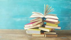 Stack of books against light blue background. Stack of books against light blue background.