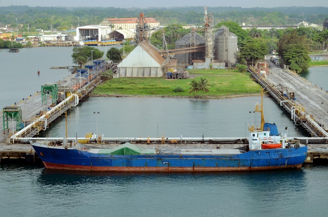 A ship waits at the Panamanian port at Cristobal, one of two ports being divested from Chinese ownership to a U.S.-Italian partnership.