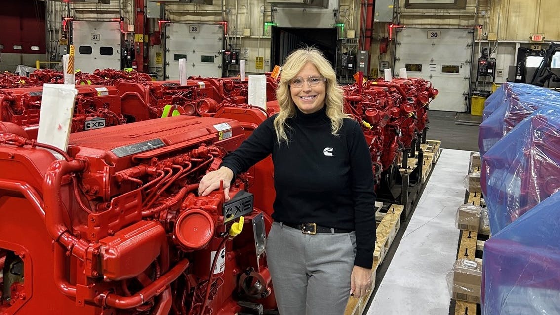 Anna Dibble stands beside some of the machinery installed for production of Cummins's 2027 X15 engine, at the Jamestown Engine Plant.