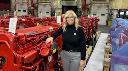 Anna Dibble stands beside some of the machinery installed for production of Cummins's 2027 X15 engine, at the Jamestown Engine Plant.