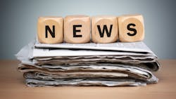 Dice that spell out news on top of a stack of newspapers Dice that spell out news on top of a stack of newspapers