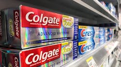 Colgate and Crest toothpaste on store shelf Colgate and Crest toothpaste on store shelf
