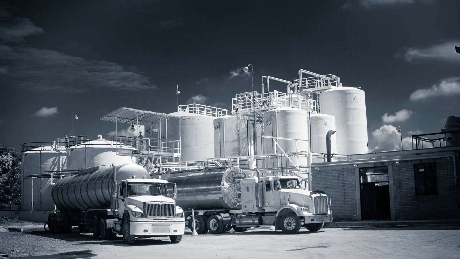 storage tanks with a semi in front of them.