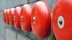 row of red alarm bells row of red alarm bells