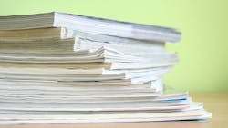 Close up of magazines against a light green background Close up of magazines against a light green background