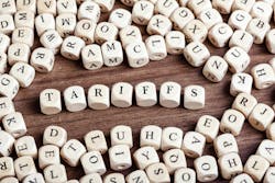 Word tariffs in letters on cube dice on table. Word tariffs in letters on cube dice on table.