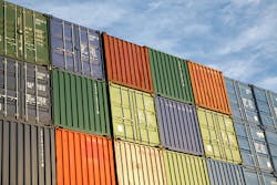 Stacked freight containers awaiting import/export at a commercial dockside. Stacked freight containers awaiting import/export at a commercial dockside.