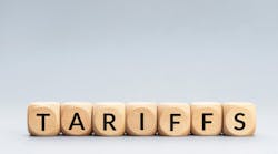 TARIFFS word on wooden blocks isolated on gray background. TARIFFS word on wooden blocks isolated on gray background.