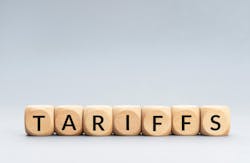 TARIFFS word on wooden blocks isolated on gray background. TARIFFS word on wooden blocks isolated on gray background.