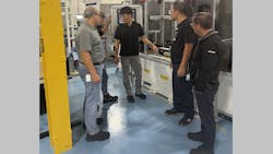 Pullmatic Mfg. Magna Powertrain team members on the Rivian line discuss progress on the project, including program manager Jacob Ham, center. Pullmatic Mfg. Magna Powertrain team members on the Rivian line discuss progress on the project, including program manager Jacob Ham, center.