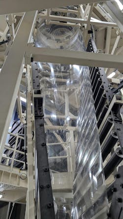 A thin tube of plastic flows upward toward heaters that will fill the sheath with hot air, expanding the film by blowing a giant bubble. The process stretches the plastic shrink wrap, making it the thickness of about a quarter of a human hair, yet the process risks popping the bubble and losing that batch of film. A thin tube of plastic flows upward toward heaters that will fill the sheath with hot air, expanding the film by blowing a giant bubble. The process stretches the plastic shrink wrap, making it the thickness of about a quarter of a human hair, yet the process risks popping the bubble and losing that batch of film.