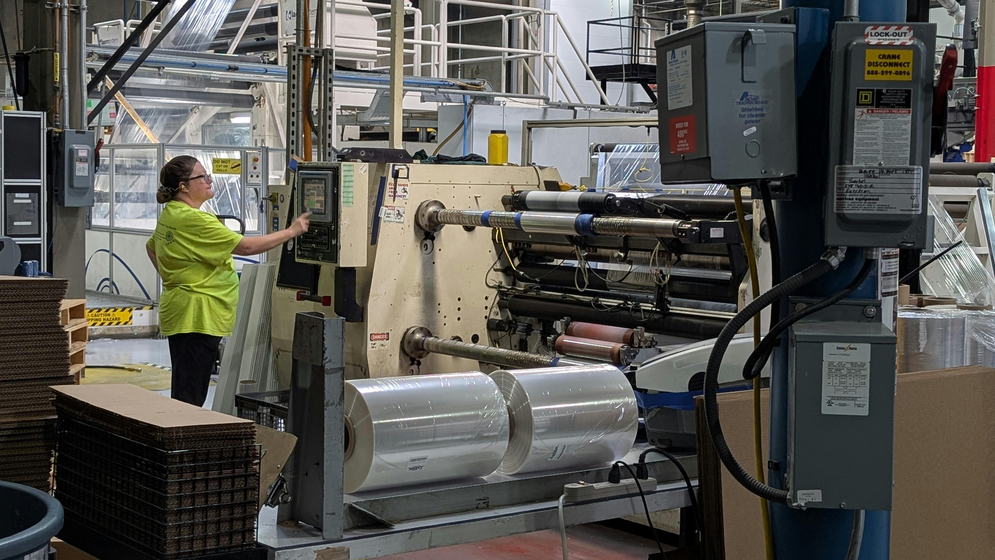 Once stretched to extreme thinness, employees roll shrink wrap films on rollers before sending them to customers who will wrap frozen pizzas, pallets of tissue paper, pharmaceuticals and other products with the plastic.