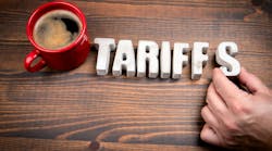 Concrete alphabet letters spelling 'Tariffs' and coffee mug on dark wooden texture background. Concrete alphabet letters spelling 'Tariffs' and coffee mug on dark wooden texture background.