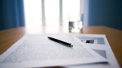 Image of workplace with focus on papers and pen on the table Image of workplace with focus on papers and pen on the table