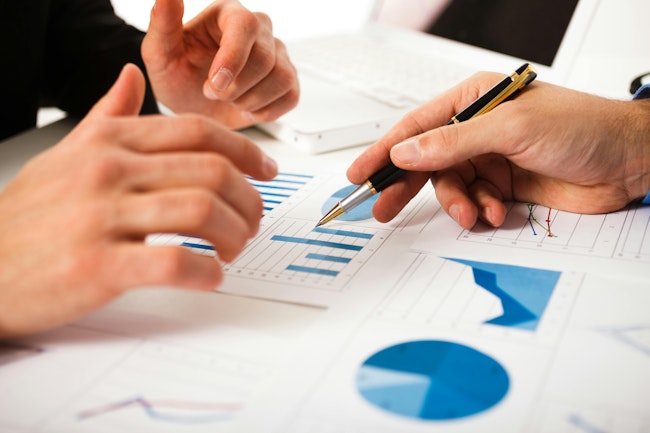 Business people discussing data during a meeting.