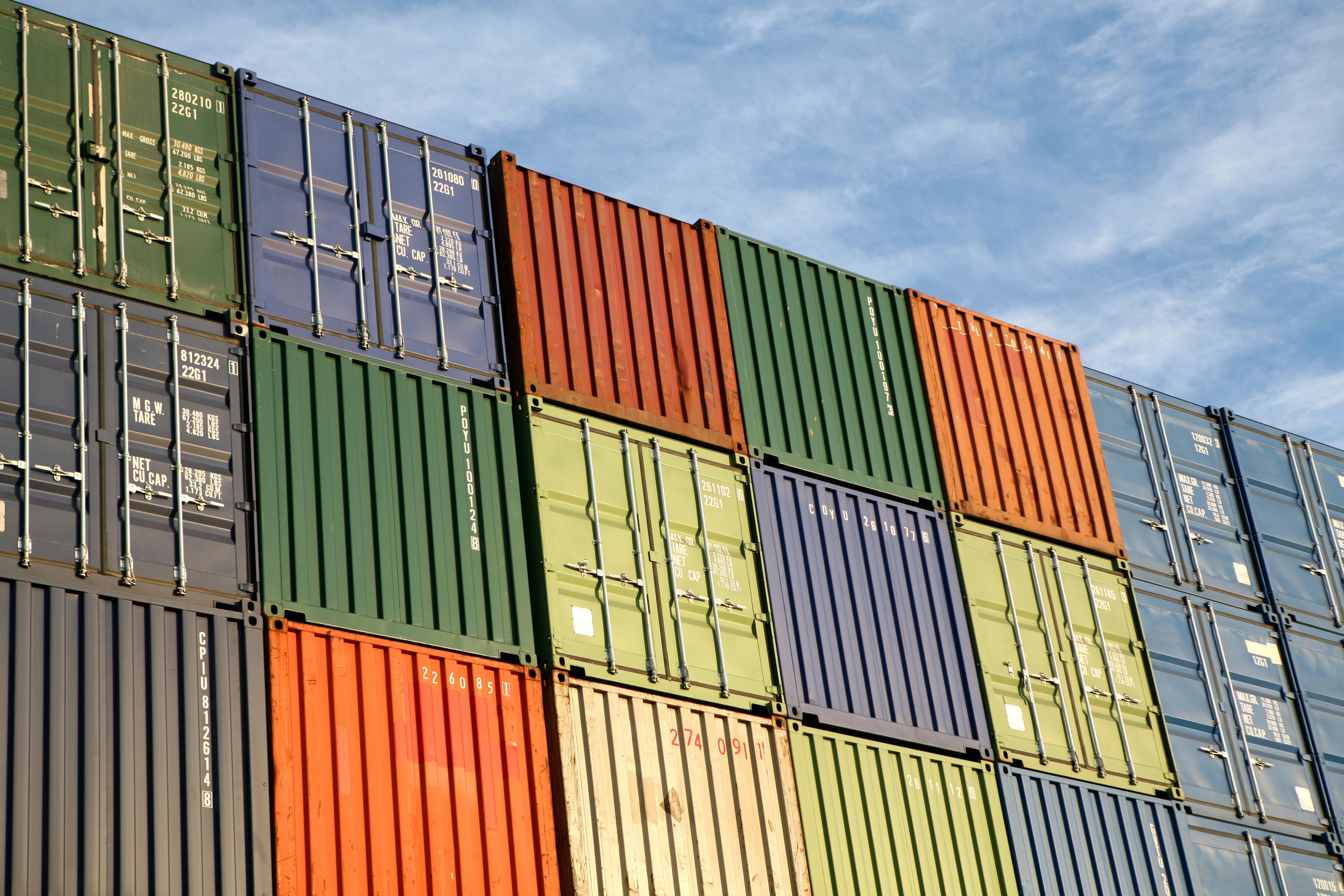 Stacked freight containers awaiting import/export at a commercial dockside.