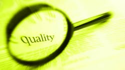 the word 'quality' inside a magnifying glass the word 'quality' inside a magnifying glass