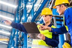 Worker and forklift driver in industrial factory Worker and forklift driver in industrial factory