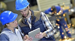 factory_workers_holding_digital_tablet factory_workers_holding_digital_tablet