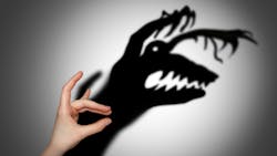 hand making a shadow of a monster on the wall. hand making a shadow of a monster on the wall.