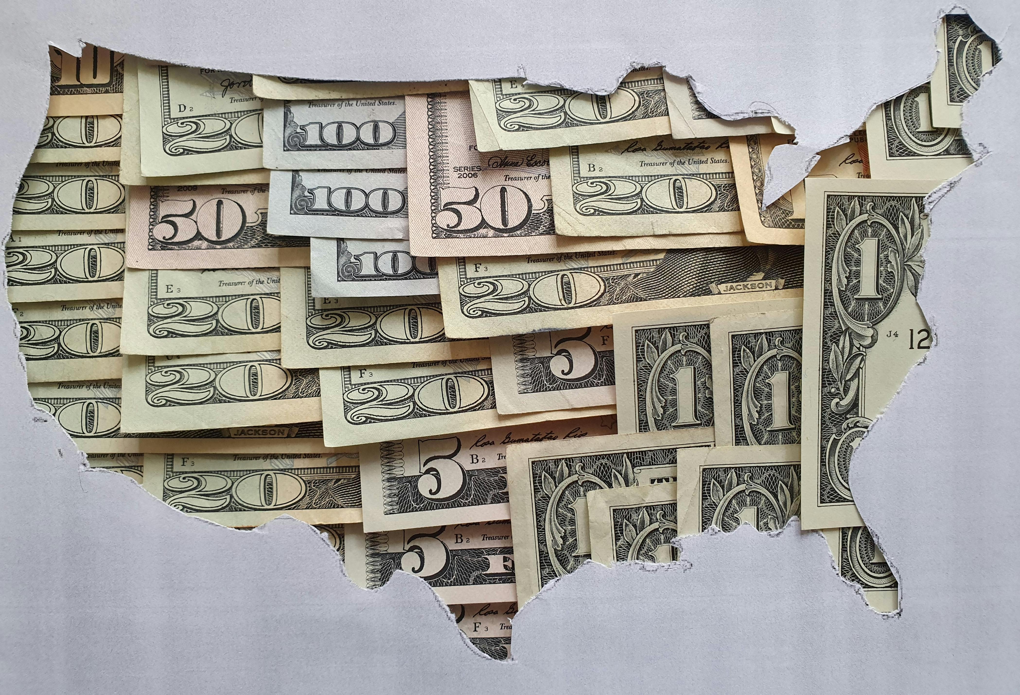 United States of America map formed with American dollars bills and gray background