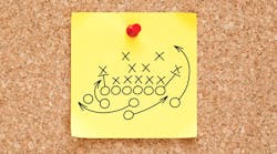 Post-It Note on a Cork Board with a Sports Play on it. Post-It Note on a Cork Board with a Sports Play on it.