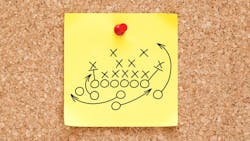 Post-It Note on a Cork Board with a Sports Play on it. Post-It Note on a Cork Board with a Sports Play on it.