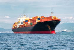 Commercial cargo ship carrying containers Commercial cargo ship carrying containers
