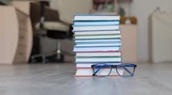 stack of books on the floor with a blurry background stack of books on the floor with a blurry background