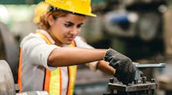 Worker controls metal lathe machine Worker controls metal lathe machine