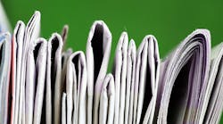 partial view of a stack of newspapers partial view of a stack of newspapers
