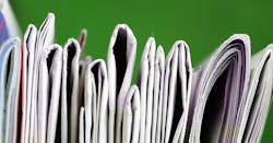 partial view of a stack of newspapers partial view of a stack of newspapers