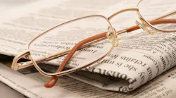 eyeglasses resting on a folded newspaper eyeglasses resting on a folded newspaper