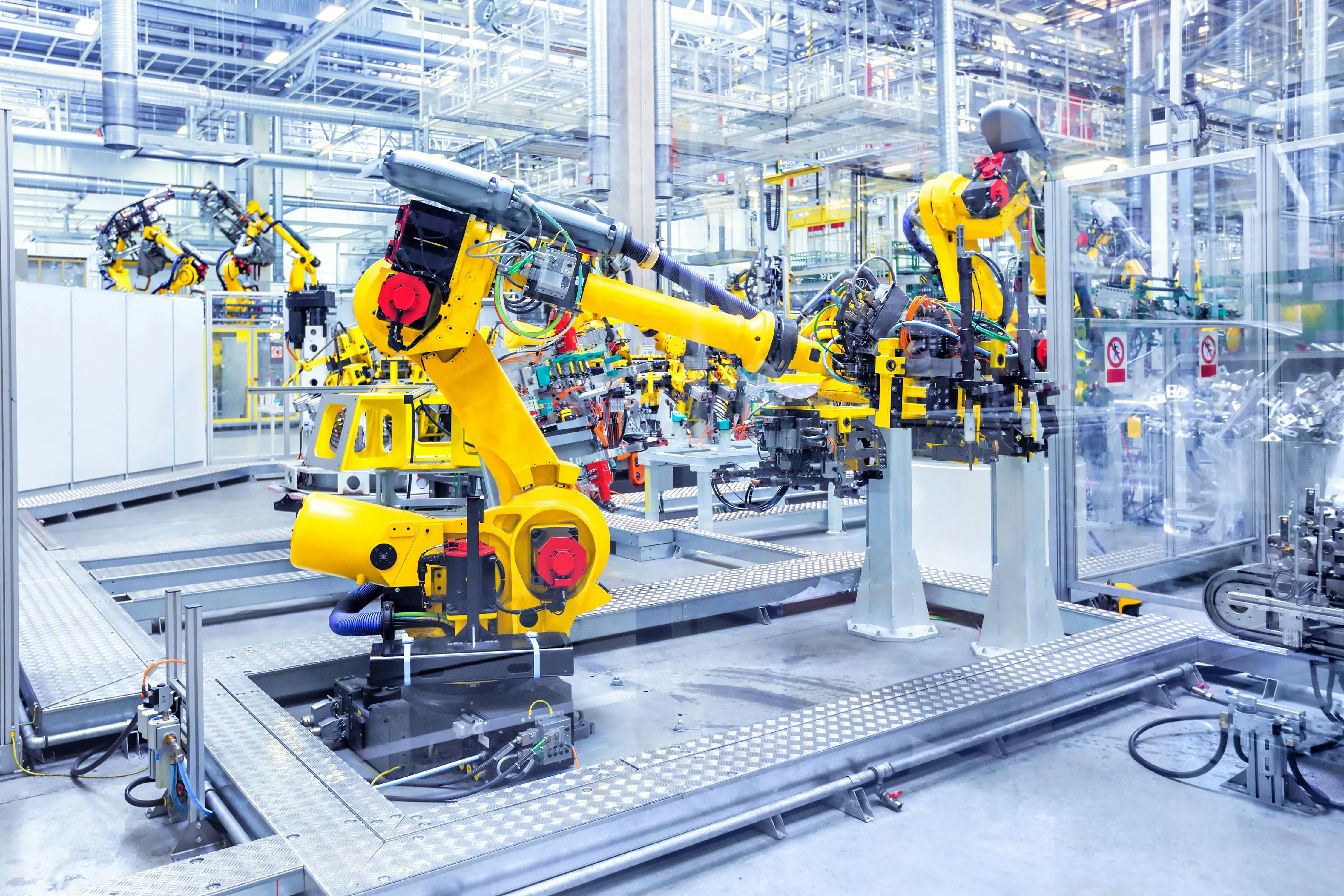 Robotic arms in a car plant