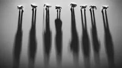 Viewed from above, a group of people casting long shadows. Viewed from above, a group of people casting long shadows.