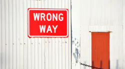 Wrong way sign on a building Wrong way sign on a building