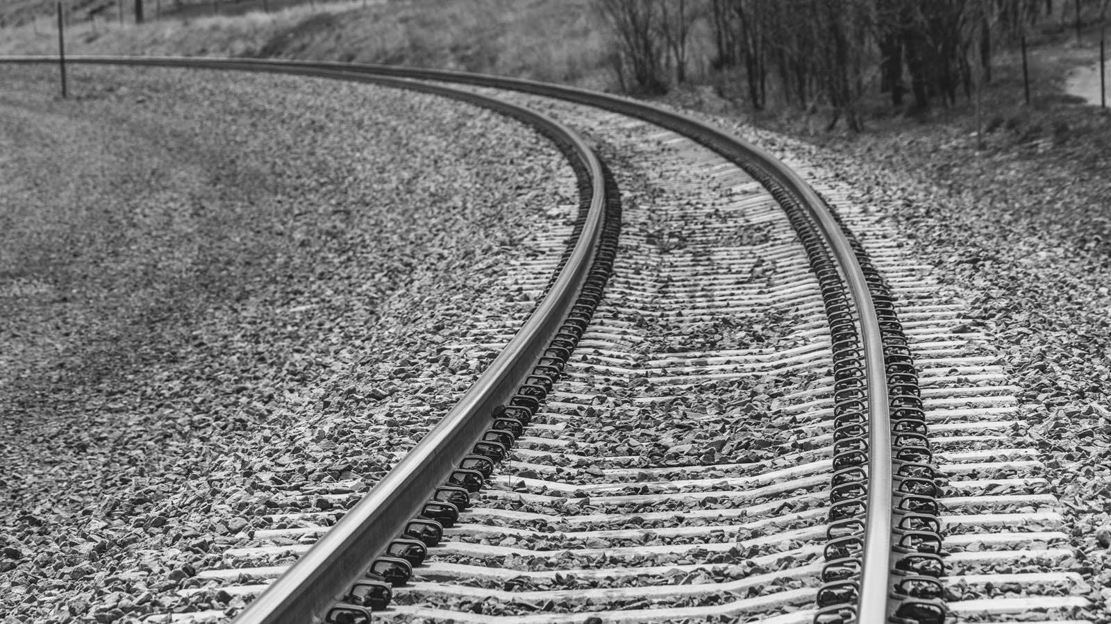 railroad track, veering left. Black and white.