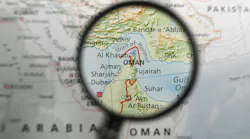 Map of Strait of Hormuz and surrounding area under magnifying glass.