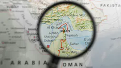 Map of Strait of Hormuz and surrounding area under magnifying glass.