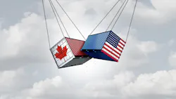 shipping containers, one Canadian and one U.S., swinging in the air