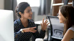 Female colleagues having a conversation at the workplace.