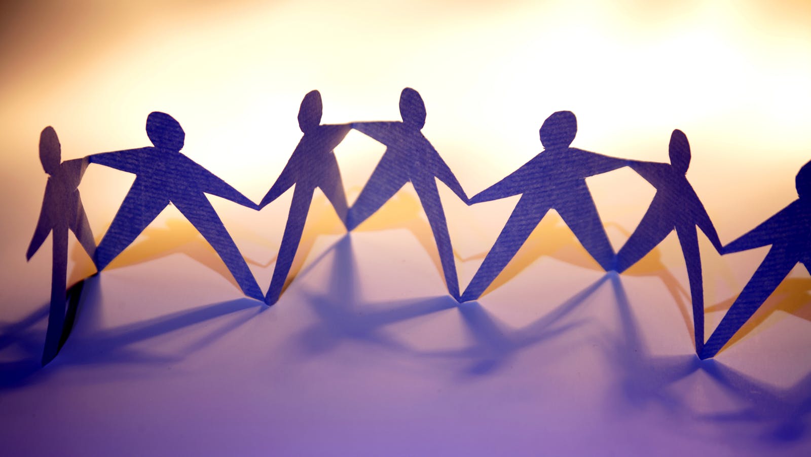line of paper dolls attached at the hands