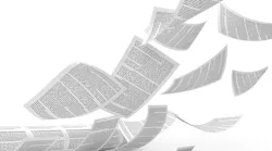 a stack of paper being blown around
