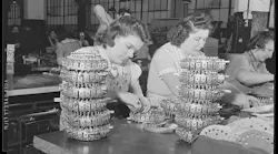 Workers assemble solonoid selectors that switch records in jukeboxes, 1942. The Wurlitzer plant was about to be converted to wartime use manufacturing electrical control devices for the military.