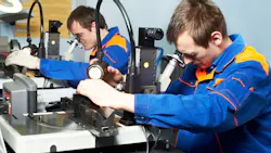 two workers examining the quality of products