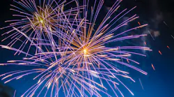 fireworks shooting off in the dark sky