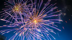 fireworks shooting off in the dark sky