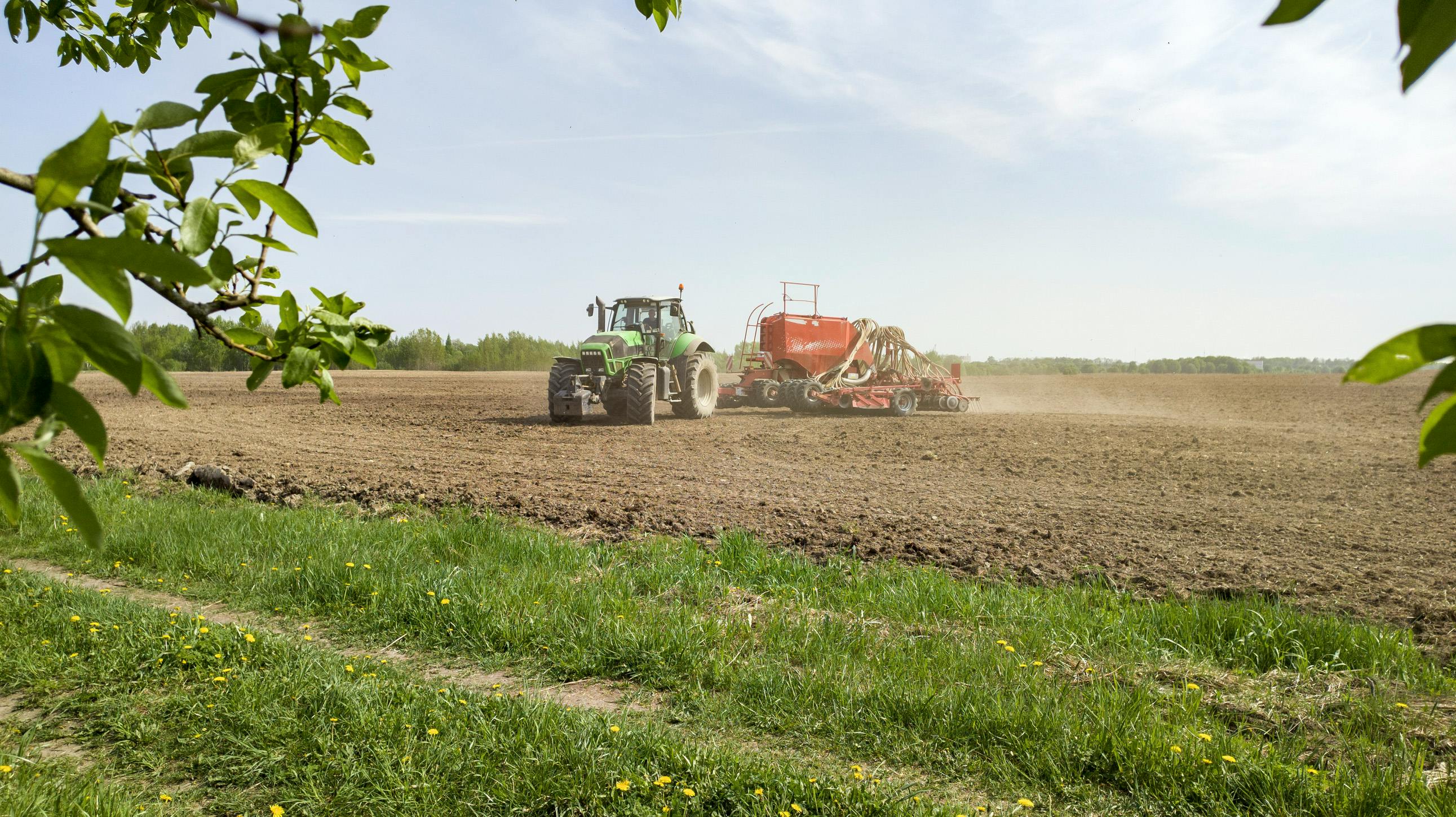 tractor in a field doing spring planting.