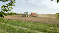 tractor in a field doing spring planting.