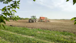 tractor in a field doing spring planting.